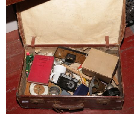 A suitcase of miscellaneous to include Metamec clock, gas mask, Smeha camera etc.