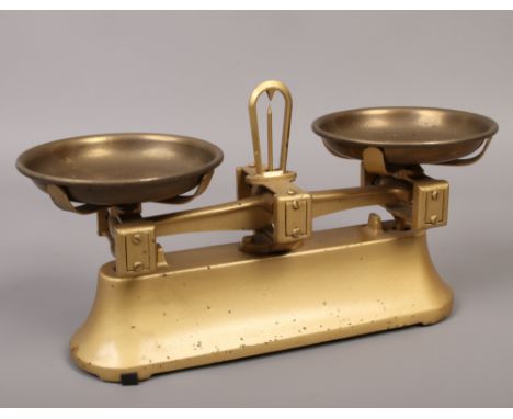 A small set of brass kitchen scales.