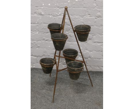 A terracotta and iron 6 pot strawberry planter.
