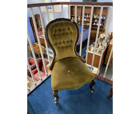 A Victorian walnut button back nursing chair