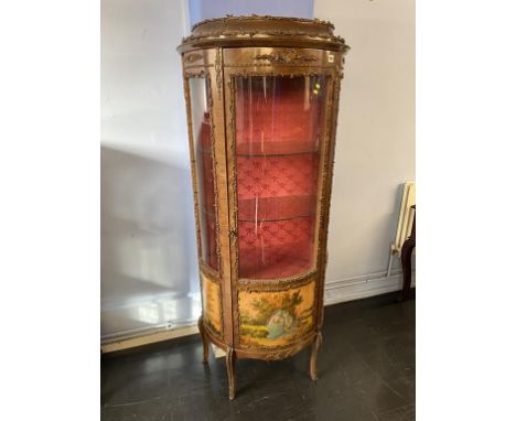 A Louis XV style vitrine, with bow front door and three decorative panels