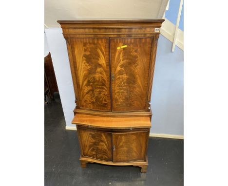 A reproduction mahogany bow front cocktail cabinet