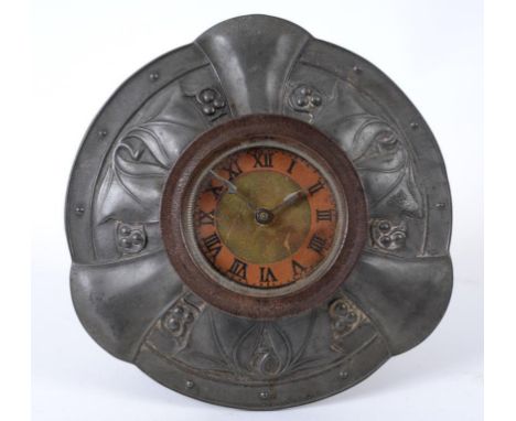 A Liberty & Co Tudric pewter desk clock, of circular easel form, with embossed foliate decoration, stamped 0986, 13 cm high  