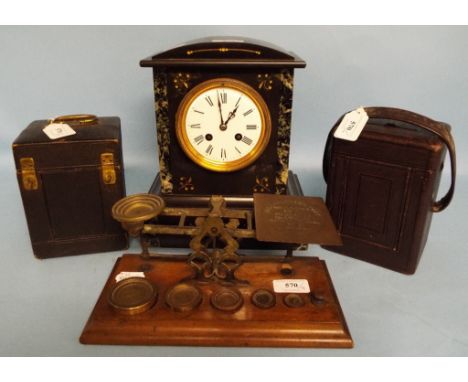 A slate and marble mantel clock, two carriage clock travelling cases, and a set of postal scales and weights (4)