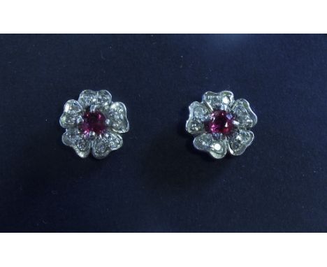 A pair of ruby and diamond flowerhead stud earrings, boxed