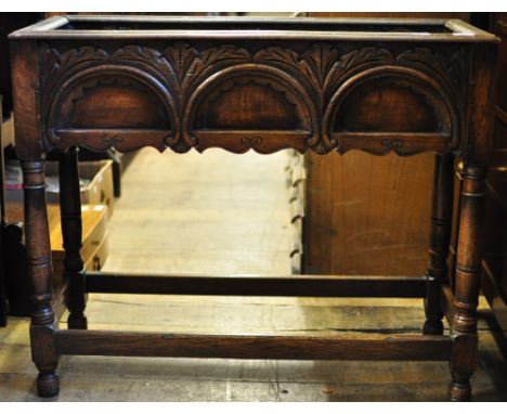 A carved oak planter, on turned legs, 92 cm wide