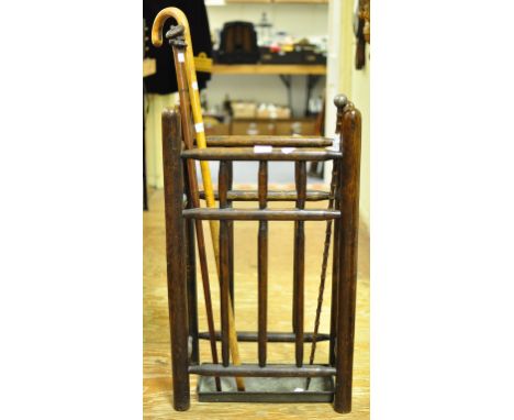 An oak stick stand, 44 cm wide, two walking sticks, a walking cane, a nest of three occasional tables, a pottery comport, and