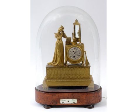 A 19th century French figural mantel clock, the silvered dial having Roman numerals, fitted a 30 hour movement, applied a lad