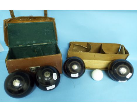 A set of four lignum vitae bowling woods, with silver coloured metal mounts, initialled, Thomas Taylor Glasgow, and a ceramic