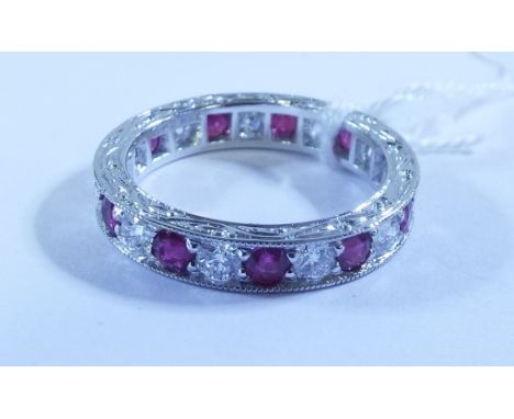 A diamond and ruby eternity ring, in a white coloured metal setting