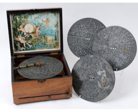 A Polyphon, with six discs, in a walnut case, 25.5 cm wide  See illustration Condition report Report by RB

The movement wind