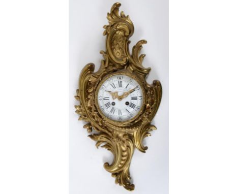 A late 19th century French cartel clock, the white enamel dial having Arabic and Roman numerals, fitted an eight day movement