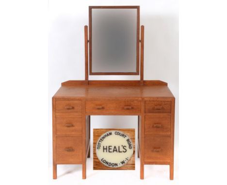 A Heal's oak dressing table, 106 cm wide, with a matching two door wardrobe, 121 cm wide, and a linen chest, 76 cm wide (3)  