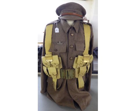 A British Army tunic with webbing belts; and a peaked cap (Please Note: this lot is subject to the statement made in the Auct