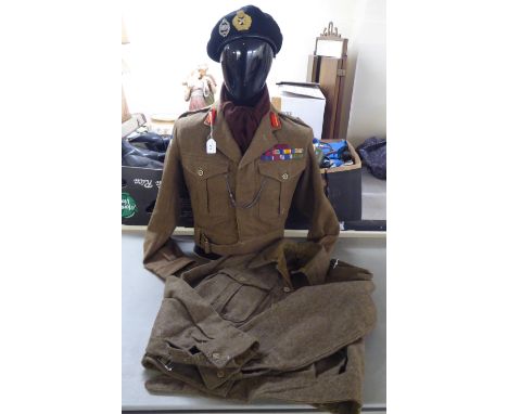 Two vintage British Army battledress tunics, one with emblems and an associated beret (Please Note: this lot is subject to th