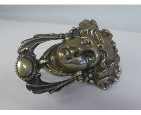 An Art Nouveau period cast brass door knocker, fashioned as a female head, adorned with leaves and berries&nbsp;&nbsp; 
