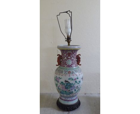 A late 19thC Chinese porcelain table lamp of waisted form, decorated in pastel tones with birds amongst flora and foliage, on