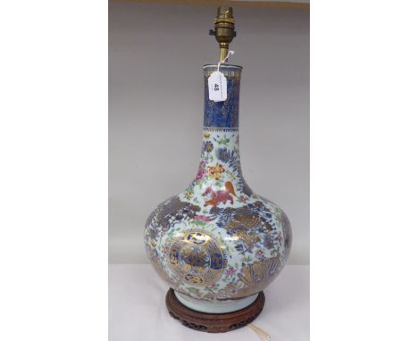 An early 20thC Chinese porcelain bottle vase design table lamp, decorated in colours and gilding with floral designs, dragons