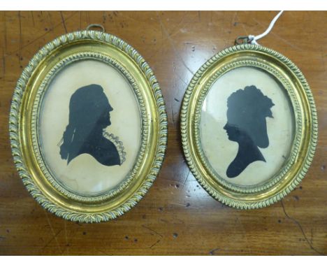 Two similar 19thC oval profile portrait head and shoulders portrait miniature silhouettes, each featuring a young woman with 