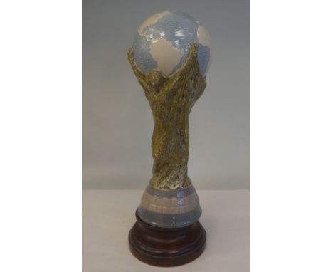 A Lladro porcelain model, a football World Cup trophy, on an associated plinth&nbsp; 15"h overall 