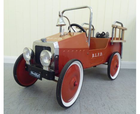A Duddy painted model pedal car, in the form of a fire truck with rubber wheels&nbsp; 37"L overall&nbsp; 
