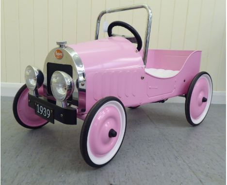 A Baghera painted model pedal car, in pink livery with rubber wheels&nbsp; 32"L overall&nbsp; 