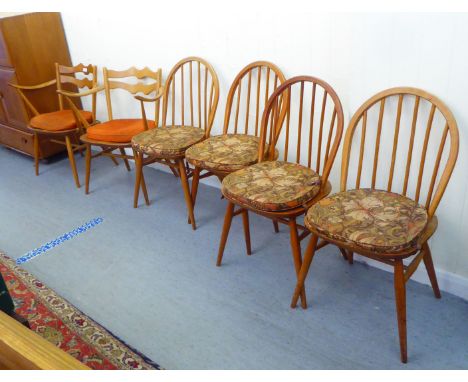 A matched set of six Ercol beech and elm framed dining chairs, comprising four standard/two open arm 