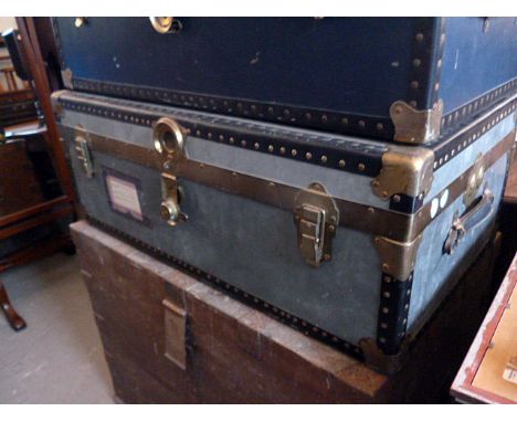 A blue travelling trunk, having brass fittings