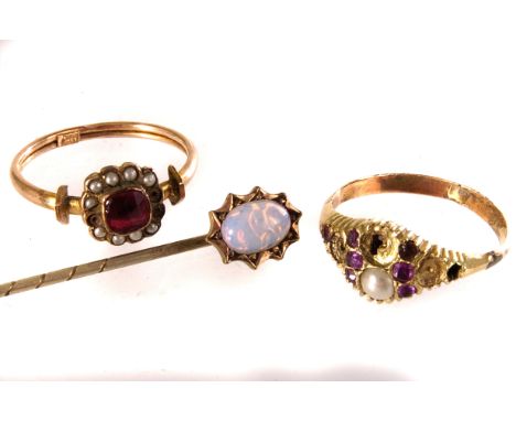 A 9ct gold ruby and seed pearl dress ring, together with another similar example, plus a gold and opal stick pin (3)