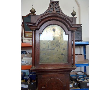 A late 18th century arch brass dial longcase clock, with 8 day movement, and carved design to top