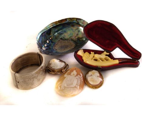 A collection of shell cameos, together with a meerschaum pipe, a silver bangle and a boxed Pana Shell by Ocean Gems