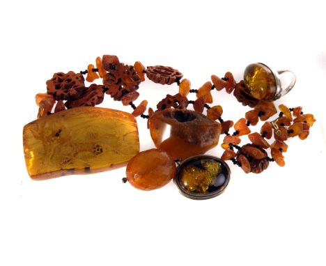 A collection of amber and amber style jewellery, including a silver dress ring, a pair of white metal mounted earrings and br