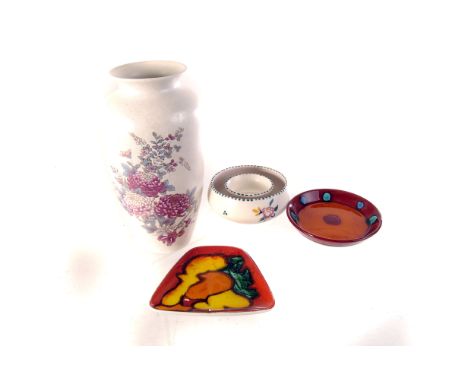 A selection of Poole pottery items, including a florally decorated vase, an Egyptian style decorated plate, and dishes or dif