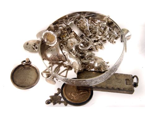 A collection of silver jewellery, comprising a charm bracelet with approx. 18 charms, a christening bracelet, a pair of cuffl
