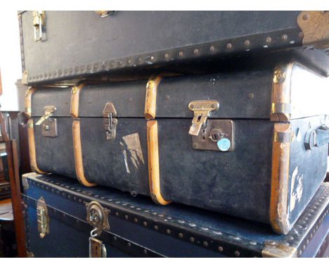 A blue travelling trunk, having brass fittings