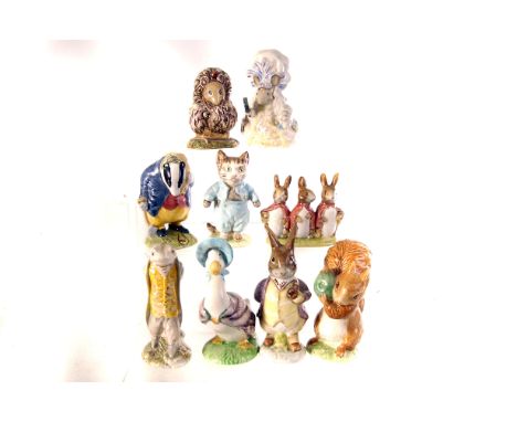 An assortment of nine Beswick Beatrix Potter ceramic figures, including Sir Isaac Newton, Tommy Brock, Flopsy, Mopsy and Cott