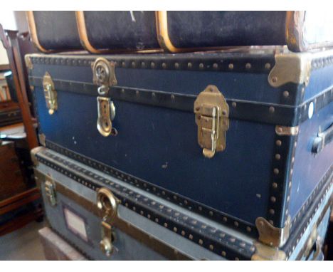 A blue travelling trunk, having brass fittings