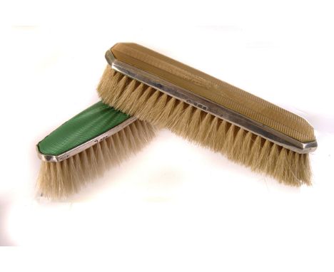 A George V silver and enamel brush, marked Birmingham 1934, having yellow enamel design to back, together with similar brush 