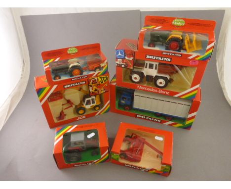 Seven boxed Britains Farm vehicles including 9519 JCB Loadall, 9580 Animal Transporter, 9597 Mercedes-Benz Detachable Tractor