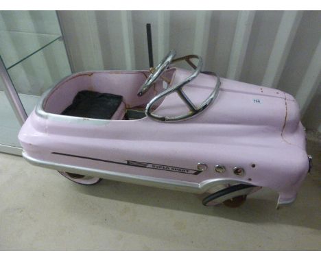 Vintage Mercury Super Sport pedal car in pink, appearing original