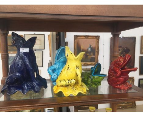 A quantity of ceramic frogs