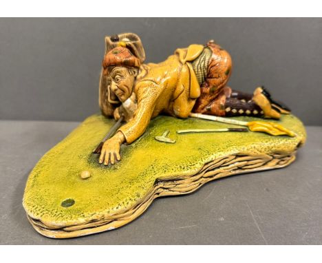A vintage clay painted figurine "The Silly Golfer"