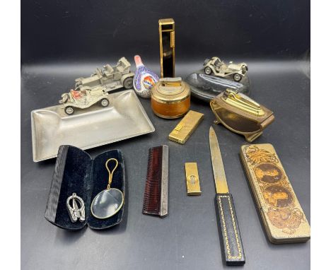 A selection of desk top curios to include lighters a silver handled comb and a gold stopper Royal Crown Derby bird 