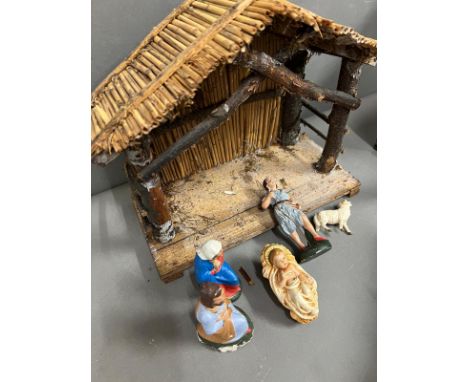 A vintage nativity scene with four figures and Christmas stable 
