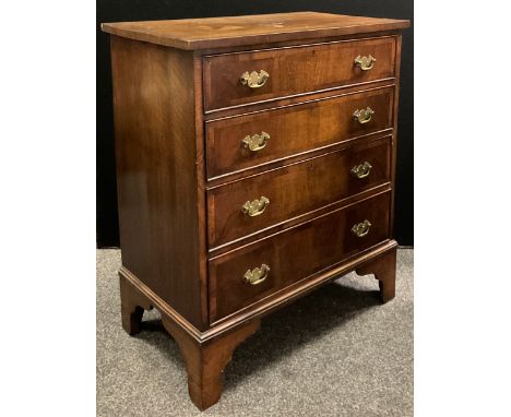 An early 20th century, George III style, reproduction walnut chest of drawers, cross-banded over-sailing top, four graduated 