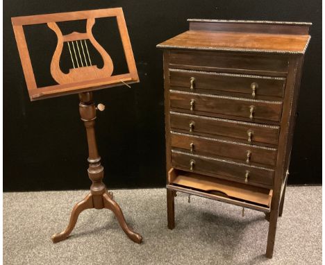 An Edwardian mahogany music cabinet, 95cm high x 53.5cm wide x 35.5cm deep, c.1910;  a mid 20th century mahogany music stand,