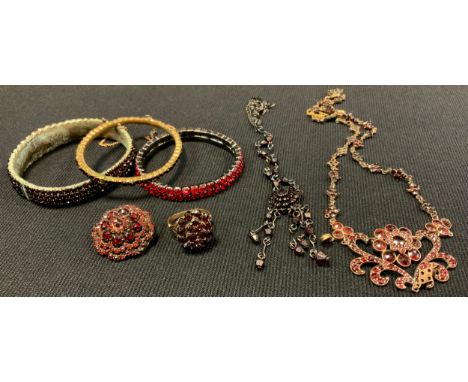 An Edwardian garnet effect paste floral heart scrolling necklace, unmarked gilt metal mount, 17.5g gross;  similar floral clu