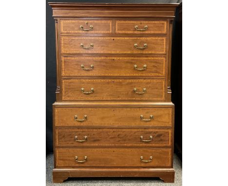 A George III style reproduction mahogany chest on chest, two short above six graduated long drawers, satinwood and ebony band