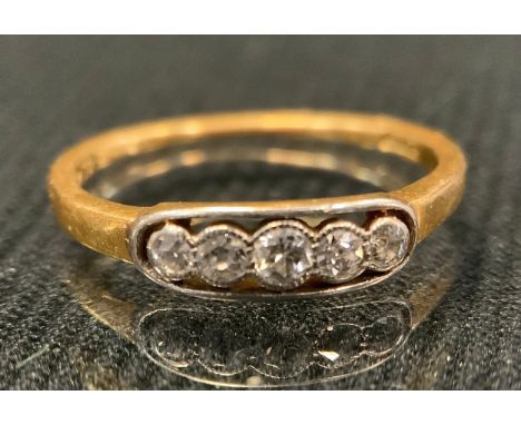 A diamond line ring, set with five old brilliant cut diamonds, total estimated diamond weight approx 0.20ct, 18 ct gold shank