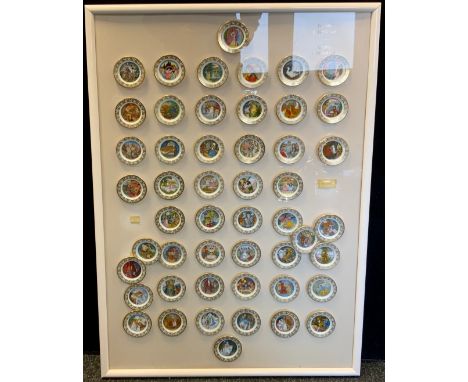 A set of fifty Franklin Mint miniature porcelain fairy tale plates, framed as a montage, each approx 7.5cm diameter, 103cm x 